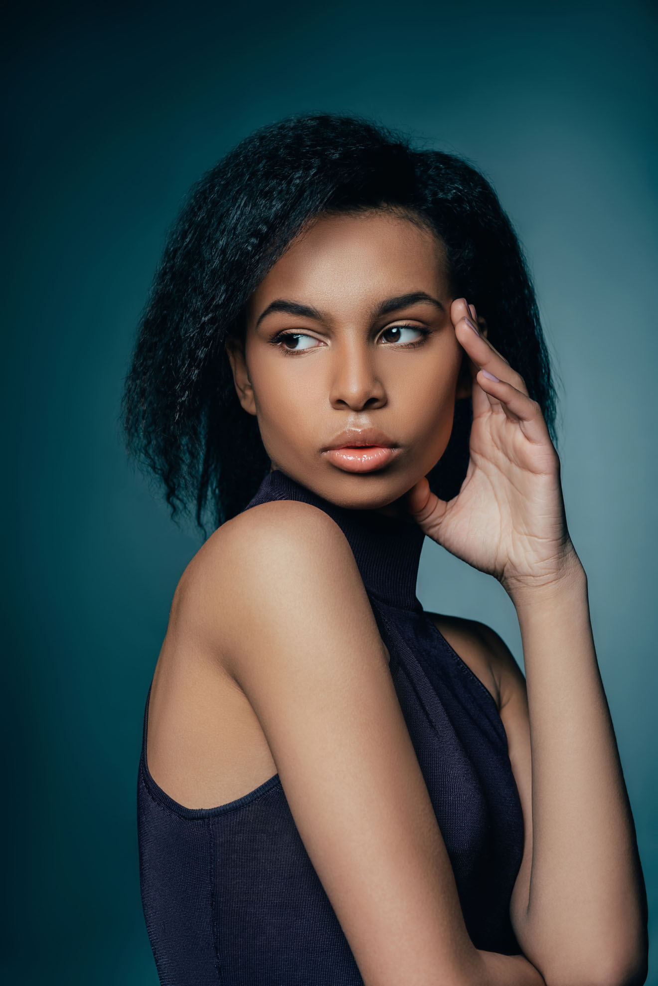 attractive african american girl posing for fashion shoot on dark blue