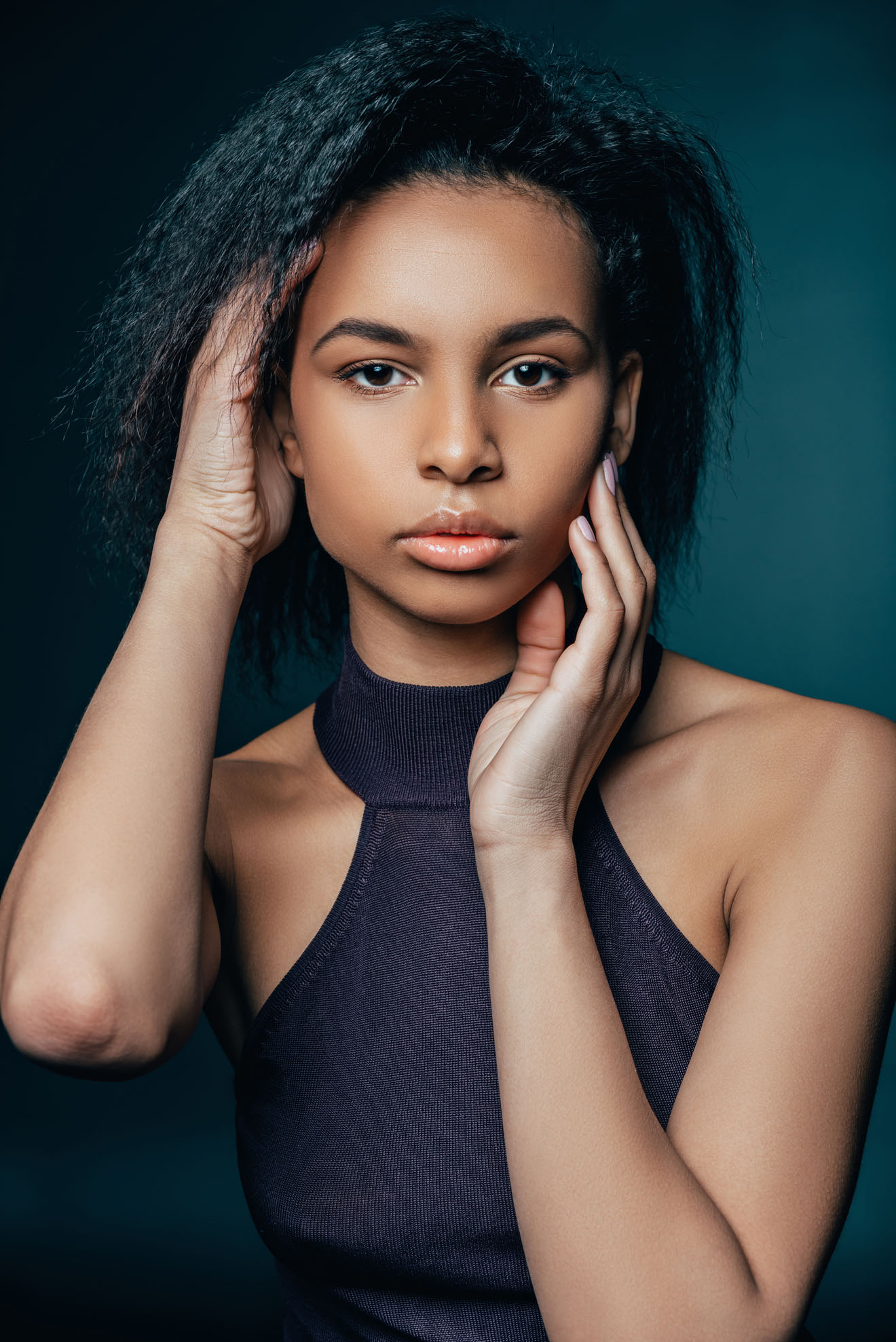 beautiful african american girl posing for fashion shoot on blue