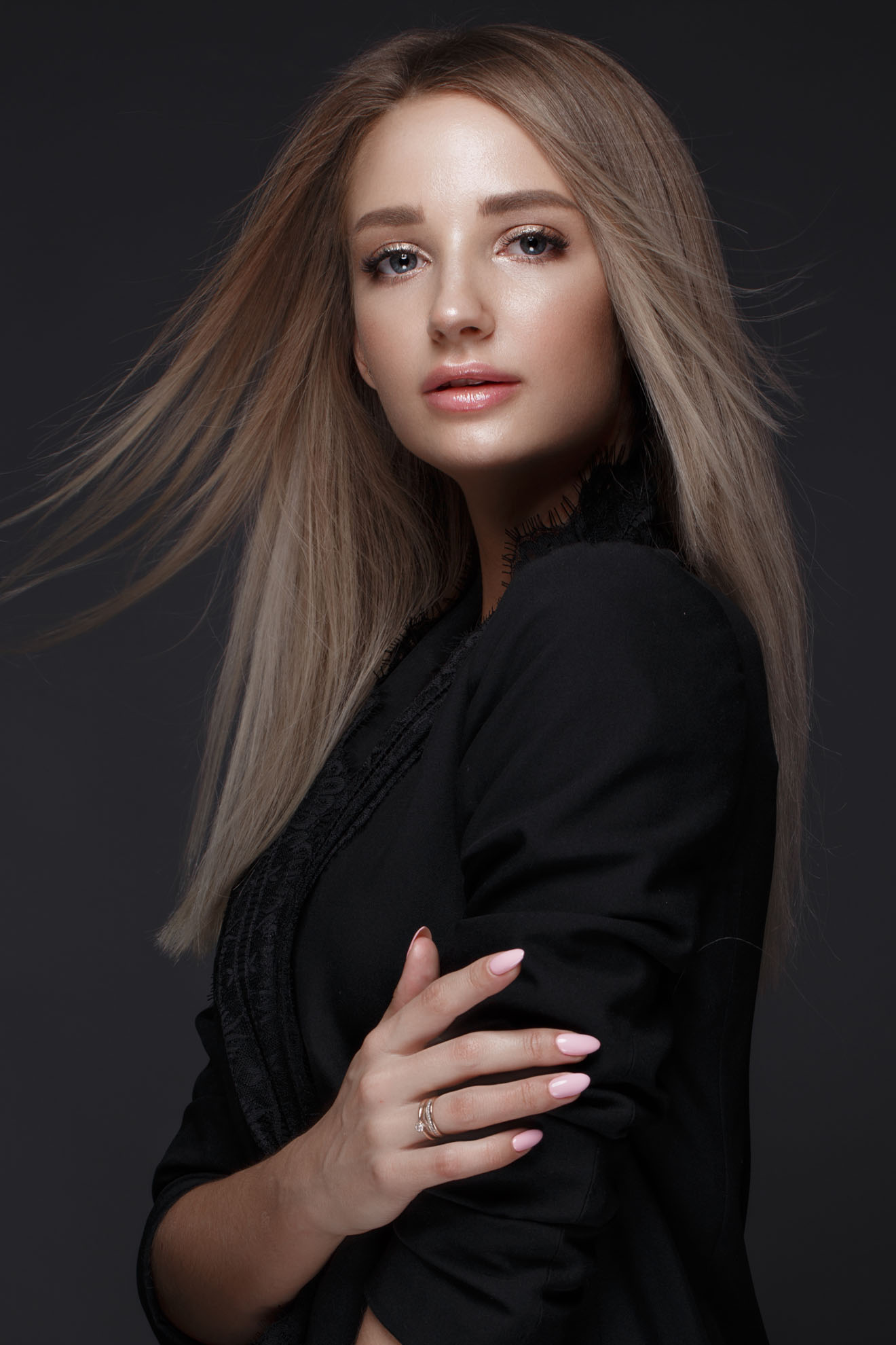 Beautiful woman with evening make-up and long straight hair . Smoky eyes. Fashion photo. Picture taken in the studio on a black background.